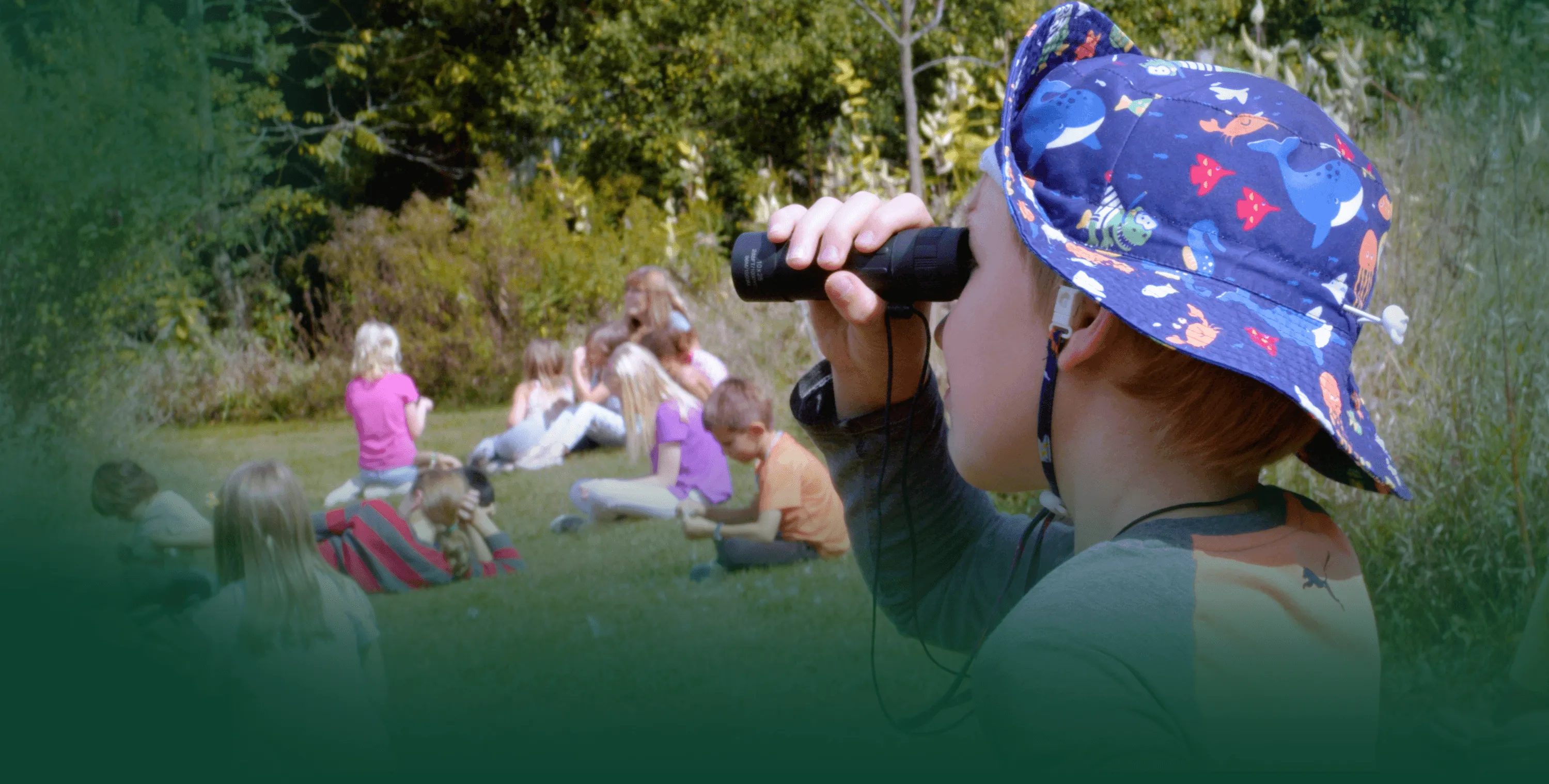 A student observes wildlife through a monocular