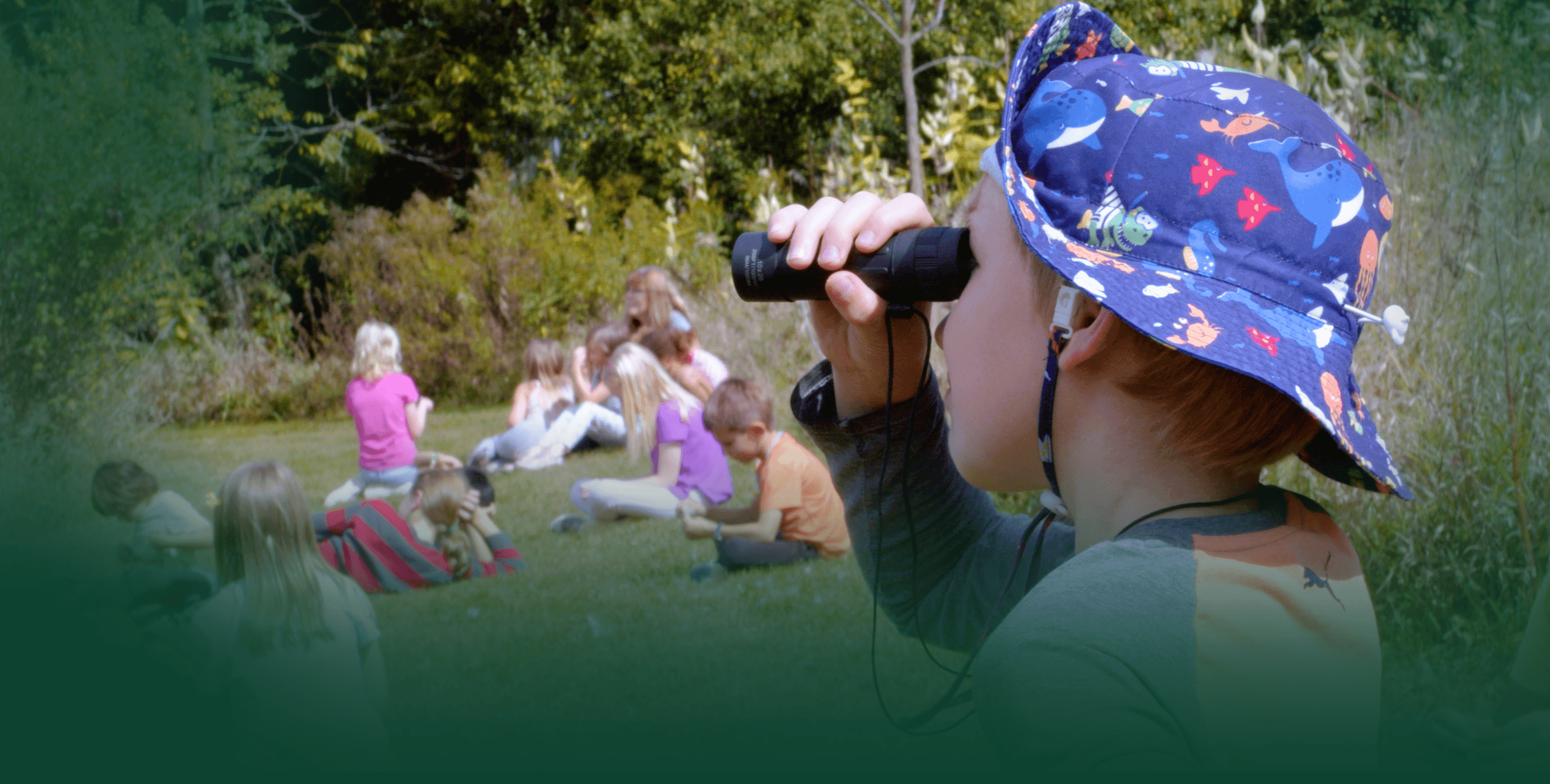 A student observes wildlife through a monocular